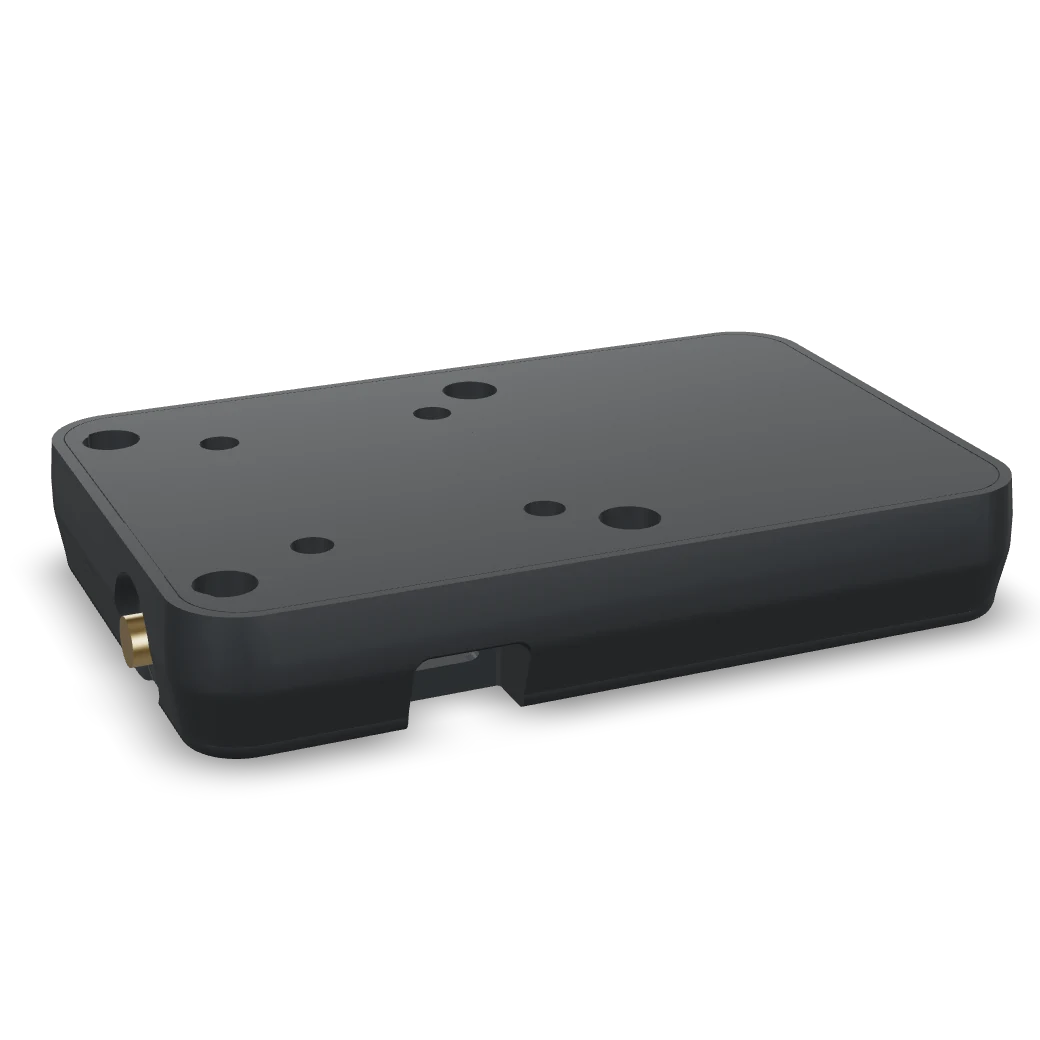 The Signum puck: a dark, rounded radio with a brass antenna connector, lit in orange